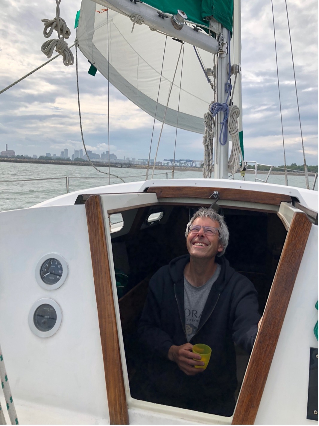 Andrew Bohm smiling from the cabin of his boat